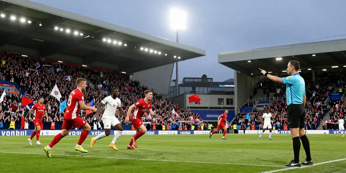 Volle stadion tijdens een spannende voetbalwedstrijd in Engeland met juichende fans en spelers in teamshirts.
